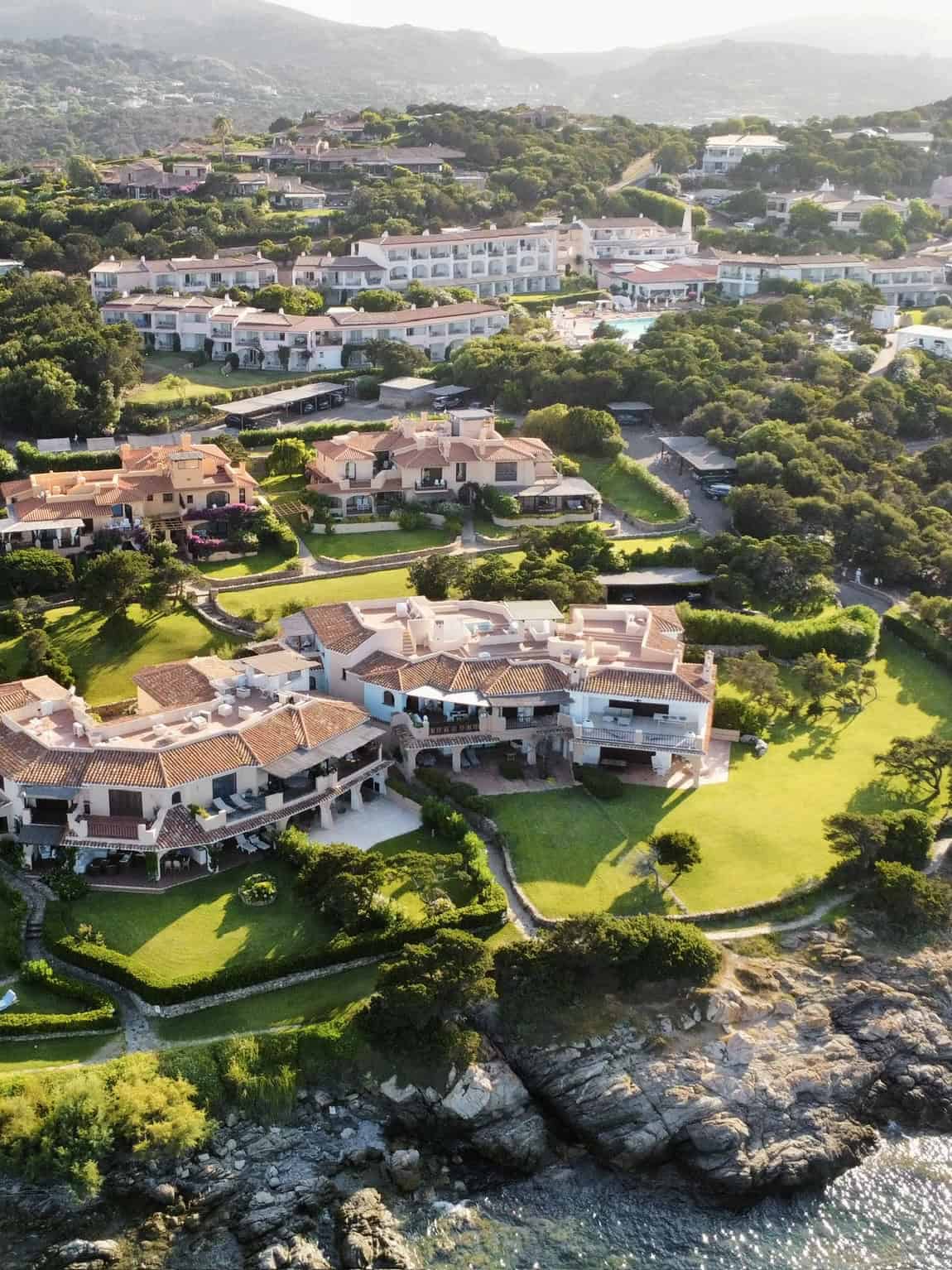 Luxury cliffside villas overlooking the ocean in a lush green landscape, offering stunning views, private terraces, and elegant architecture at Pikasea.