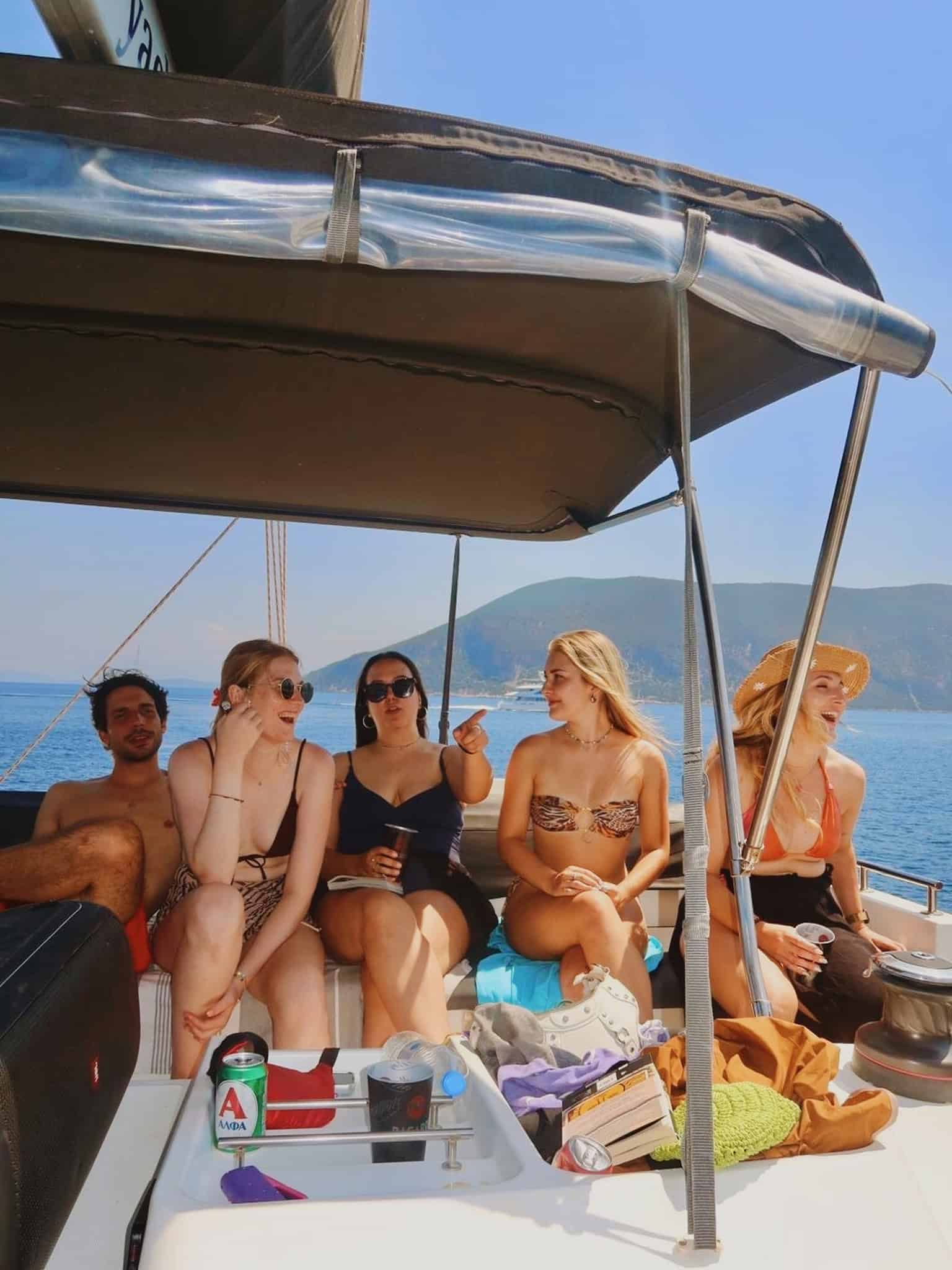 Sunset cruise with friends on a luxury boat in clear blue waters, picturesque coastlines, and relaxing summer vibes. Perfect for leisure, travel, friendship, and seaside adventure.